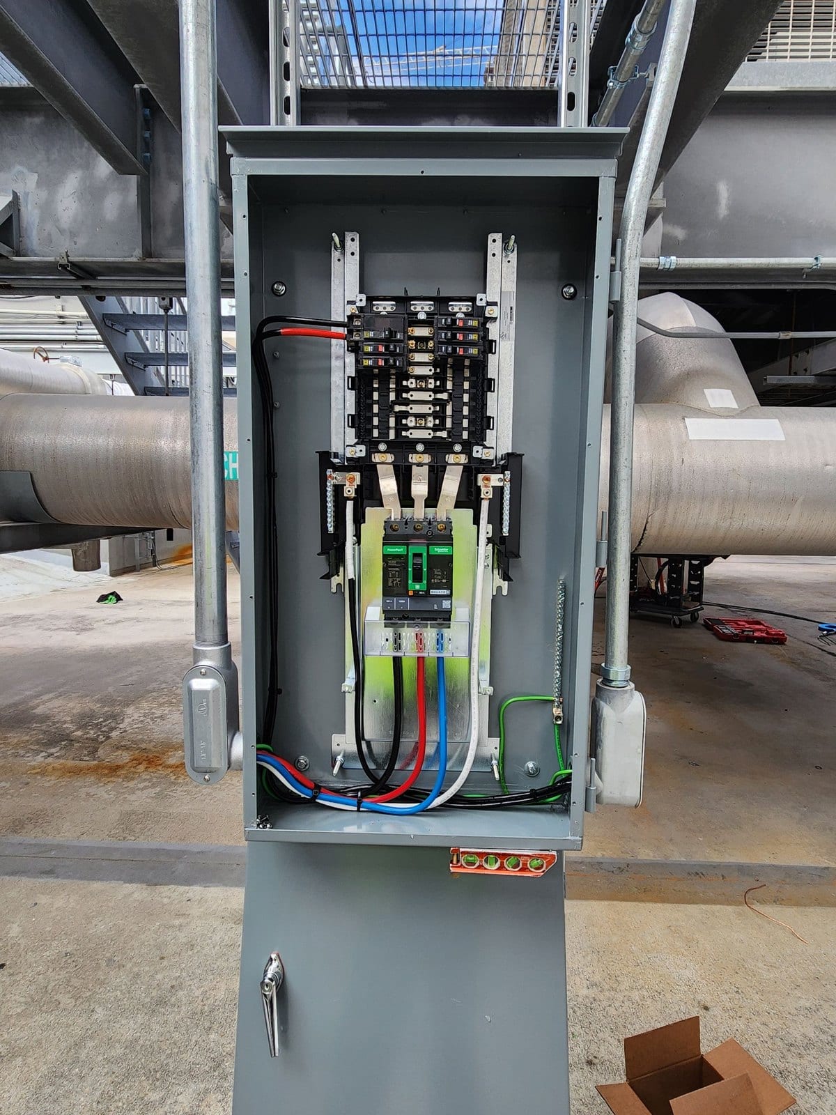 Main breaker and terminated conductors inside a freestanding outdoor service enclosure