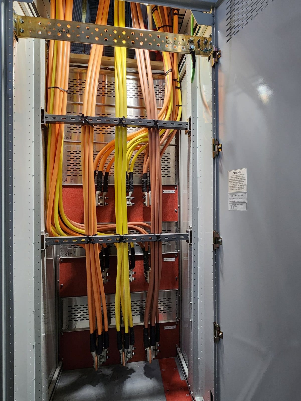 Switchgear compartment with feeder cables landed on lugs and cable bracing fitted